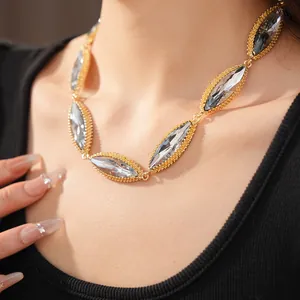 Close-up of vintage palace style necklace with marquise cut crystals in gold setting.