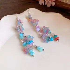 Close-up detail of colorful Mori-style resin flower and stone beaded dangle earrings