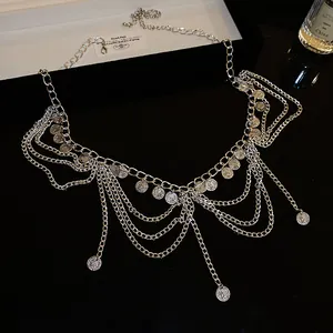 Macro view of silver ethnic multi-layer body chain with vintage bohemian coin charms