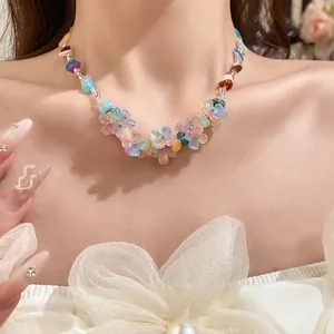 Close-up detail of a colorful resin flower and natural stone beaded choker necklace.