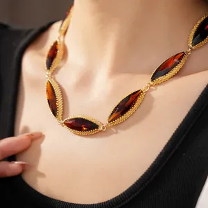 Detailed close-up of a vintage court style necklace featuring marquise-cut amber-colored stones