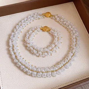 Handcrafted white pearl beaded necklace and bracelet jewelry set on luxury tray