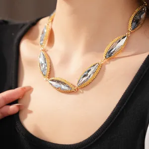 Detailed close-up of a retro court style necklace featuring marquise-cut crystals on a model