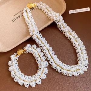 Detailed view of hand-woven pearl necklace and bracelet set with gold-tone accents