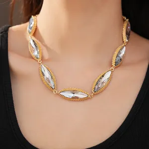 Close-up detail of a vintage court style gold necklace with marquise-shaped crystals
