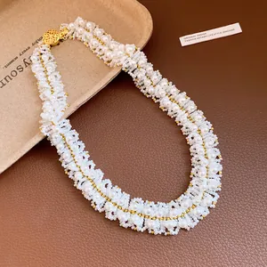Detailed view of handmade multi-strand pearl beadwork and elegant golden clasp