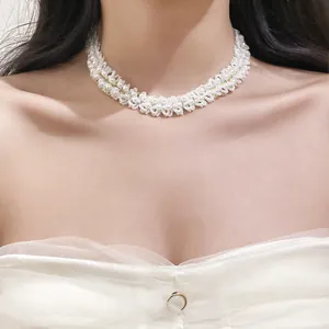 Intricate close-up detail of a white beaded pearl choker with elegant woven design