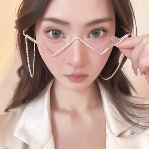 Close-up of a model wearing a unique zig-zag gold metal rhinestone frame without lenses