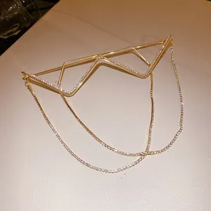 Detailed view of a gold geometric metal eyeglass frame with sparkling rhinestone chains.