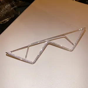 Close-up of a silver-toned metal lensless eyewear frame with rhinestone accents.