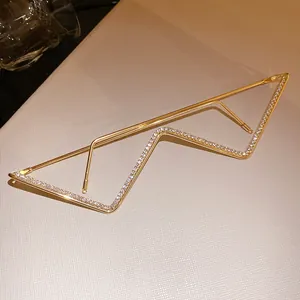 Detailed macro view of gold metal rhinestone glasses frame with unique lightning bolt design