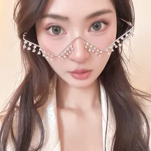 Close-up of unique silver metal eyeglass frame with hanging rhinestones on model