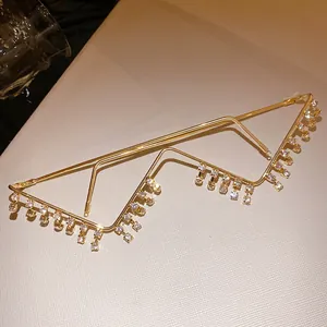 Detailed close-up of a retro gold metal glasses frame featuring elegant hanging rhinestones