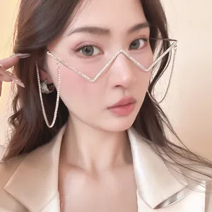 Detail shot of a model wearing retro V-shaped rhinestone metal glasses frame with tassels.