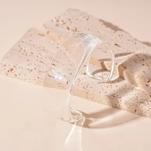 Minimalist irregular transparent wide resin bangle with a retro and artistic finish