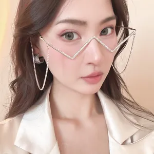 Detailed close-up of a zigzag metal eyeglass frame with rhinestones and decorative chains