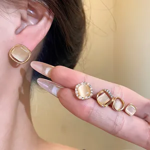 Detailed view of silver needle cat's eye stone earrings in various geometric shapes