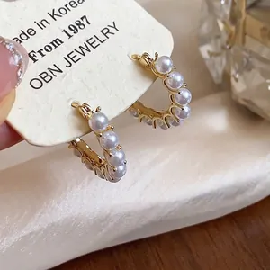 Elegant French style 14k gold plated hoop earrings adorned with delicate white pearls