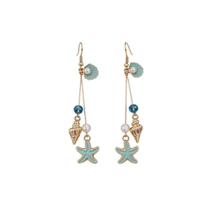 Elegant Bohemian sea star and conch dangle earrings with pearls and blue crystals