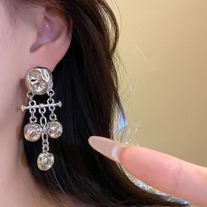 Detailed view of silver wrinkled metallic tassel earrings for an elegant retro look.