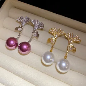 Elegant 18K gold plated ginkgo leaf drop earrings with zircons and pearls in a jewelry box