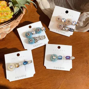 Set of elegant resin flower hair clips featuring sparkling rhinestones and chic bow designs