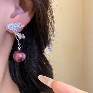 Exquisite 18K gold plated ginkgo leaf earrings featuring purple pearl drop and zircon