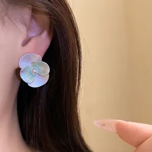 Elegant silver needle flower stud earrings with pearl center and green drop oil petals.