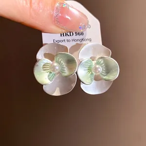 Elegant silver-toned flower stud earrings with green petals and central pearl detail