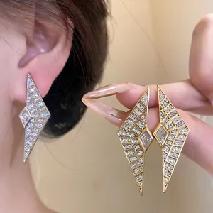 Macro view of geometric rhombus earrings encrusted with sparkling cubic zirconia