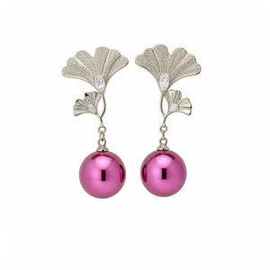 18K gold plated ginkgo leaf earrings with zircons and magenta pearls on white background