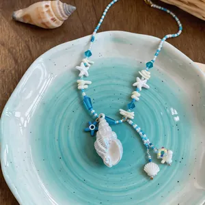 Macro view of the summer conch and starfish beaded necklace with beach elements