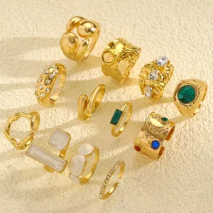 Set of vintage gold-plated rings featuring irregular textures and colorful shiny stones