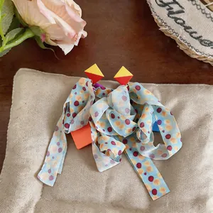 Close-up of Korean style chiffon fabric tassel earrings with colorful dot pattern