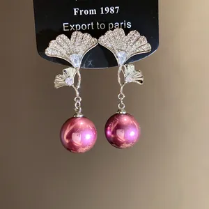 Elegant silver ginkgo leaf earrings with zircon inlay and large purple pearl dangles