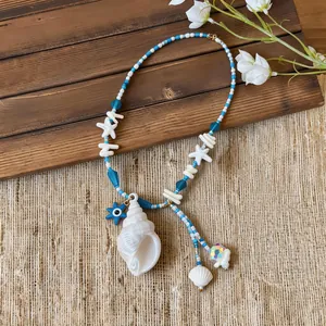 Detailed view of summer beach necklace featuring white conch shell and starfish beads