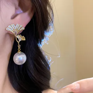 Elegant 18K gold plated ginkgo leaf earrings with zircon and large pearl drop detail.