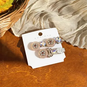 Detailed view of elegant resin flower hair clips with bow and rhinestone accents