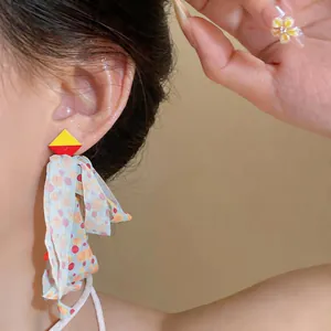 Close-up of Korean style blue chiffon fabric tassel earrings worn by a model