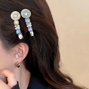 Close-up detail of sweet resin flower hair clip with colorful rhinestones on model's hair