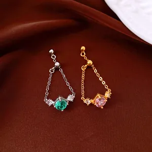 Detail of vintage zircon chain rings in silver with emerald and gold with pink stone.