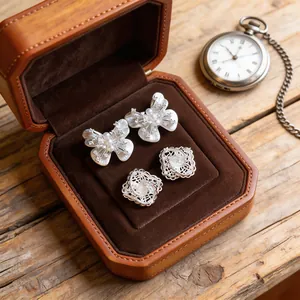 Macro view of elegant hollow flower and pearl butterfly silver needle earrings in box