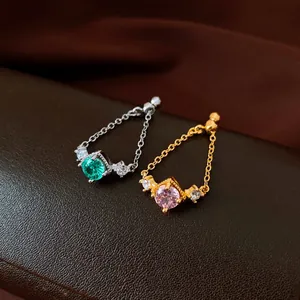 Close-up of vintage zircon rhombus chain rings in silver and gold finish
