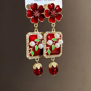 Elegant vintage red enamel flower drop earrings with pearls and crystals in palace style.