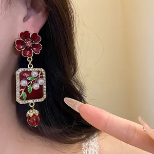 Vintage red enamel floral earrings with pearls and crystal drops in a luxurious palace style.