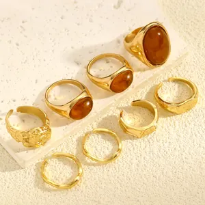 Detailed view of vintage-style gold ring set with amber stones and hammered textures