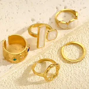 Collection of vintage golden adjustable rings with irregular textures and enamel detail