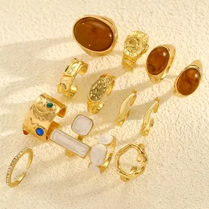 Detailed view of 12 vintage gold-toned rings with textured and gemstone designs