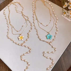 Layered pearl beaded necklace with enamel flower pendants in yellow and blue