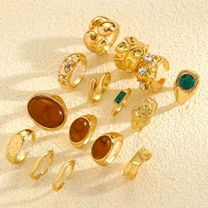 Detail view of retro irregular textured gold ring set with amber and green stones